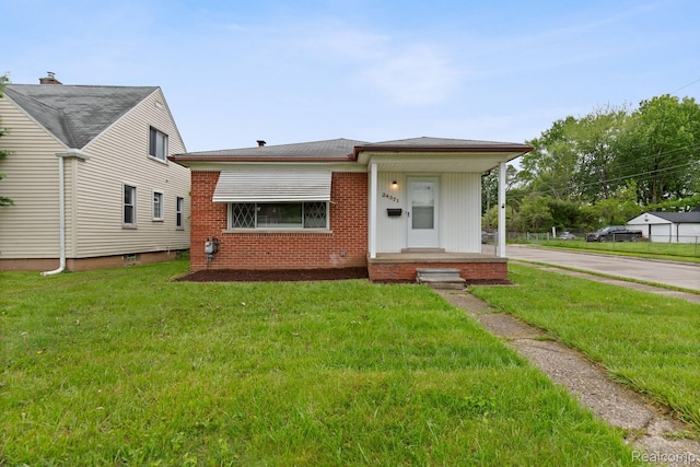 24371 Grove Ave, Eastpointe, MI 48021 - view of front facade featuring a front yard, driveway, and brick siding