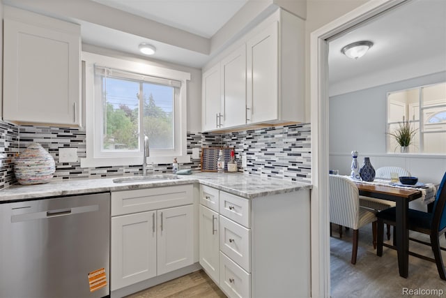 24371 Grove Ave, Eastpointe, MI 48021 - kitchen with dishwasher, light wood-type flooring, white cabinetry, light stone counters, and backsplash