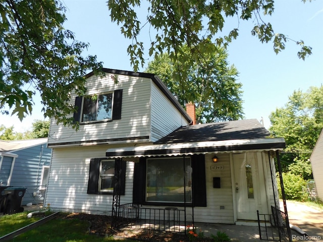 18949 Wall St, Melvindale, MI 48122 - view of front facade featuring a chimney and covered porch