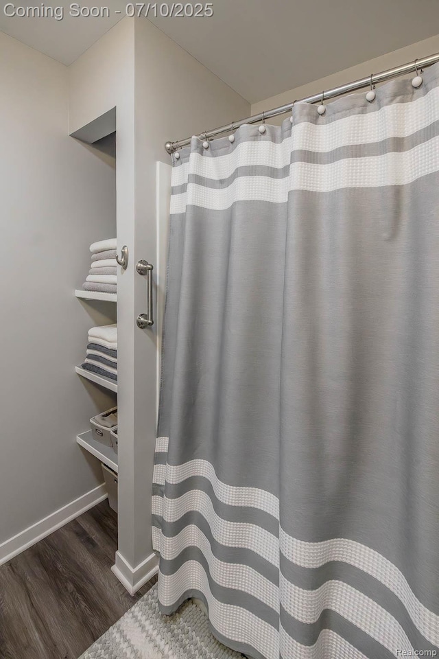 2489 Hatchery Crossing Dr, Waterford, MI 48329 - bathroom with wood finished floors and a shower with shower curtain