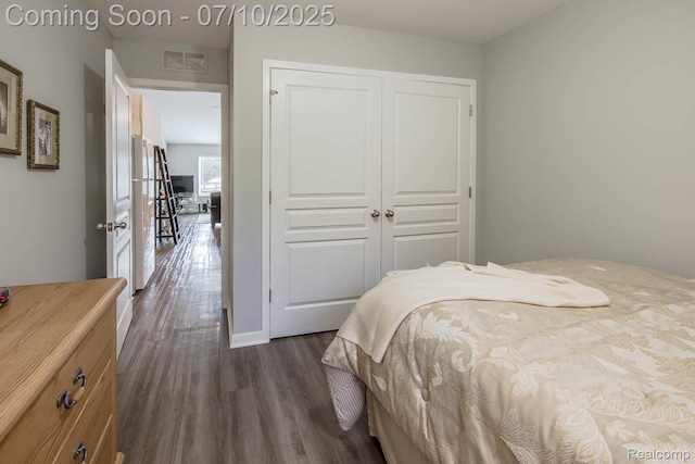 2489 Hatchery Crossing Dr, Waterford, MI 48329 - bedroom with dark wood-type flooring and a closet