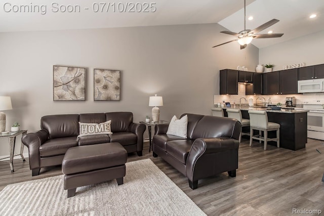 2489 Hatchery Crossing Dr, Waterford, MI 48329 - living area with wood finished floors, a ceiling fan, high vaulted ceiling, and recessed lighting
