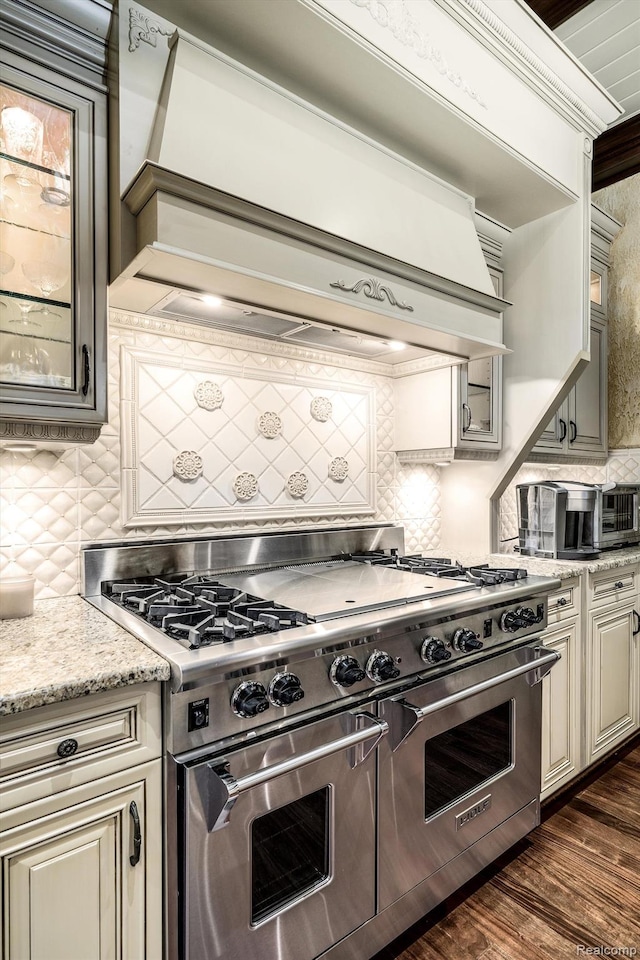 18198 Shelley Pond, Northville, MI 48168 - kitchen featuring double oven range, cream cabinets, tasteful backsplash, custom exhaust hood, and glass insert cabinets
