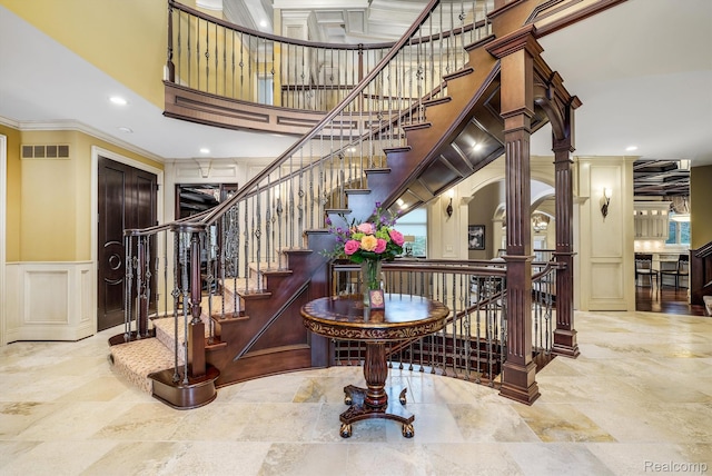 18198 Shelley Pond, Northville, MI 48168 - stairway featuring a decorative wall, crown molding, a towering ceiling, recessed lighting, and a wainscoted wall