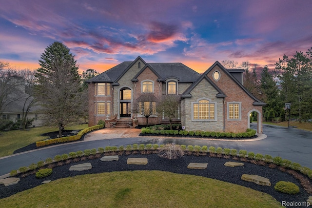 18198 Shelley Pond, Northville, MI 48168 - french country inspired facade featuring stone siding and curved driveway