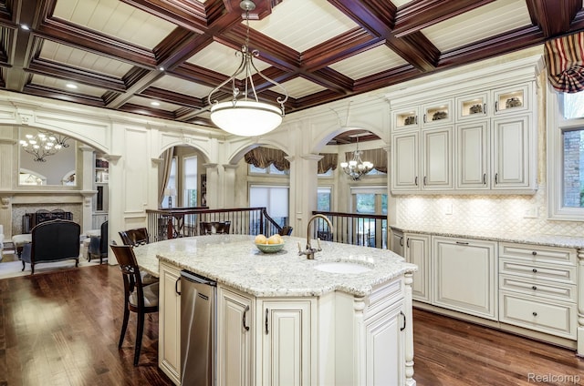 18198 Shelley Pond, Northville, MI 48168 - kitchen with a chandelier, arched walkways, a breakfast bar area, coffered ceiling, and a fireplace