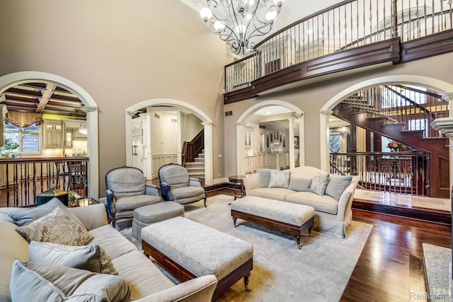 18198 Shelley Pond, Northville, MI 48168 - living area featuring stairway, wood finished floors, arched walkways, plenty of natural light, and a high ceiling