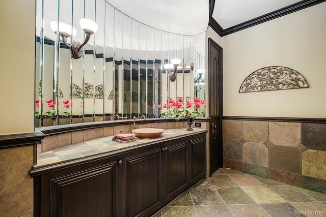 18198 Shelley Pond, Northville, MI 48168 - bathroom with stone tile floors, vanity, wainscoting, and crown molding