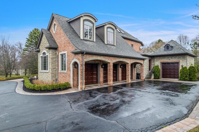 18198 Shelley Pond, Northville, MI 48168 - french country style house with asphalt driveway, stone siding, roof with shingles, and a garage