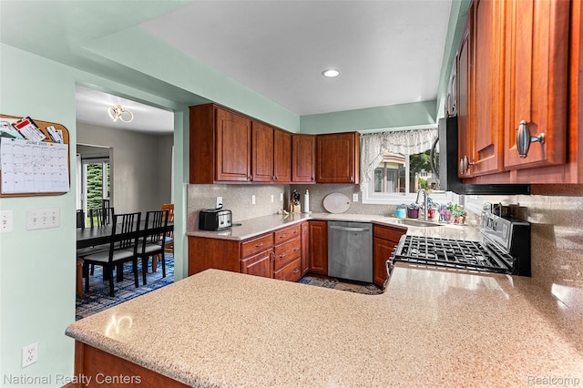 1306 Bishops Ter, Wixom, MI 48393 - kitchen with appliances with stainless steel finishes, healthy amount of natural light, backsplash, a peninsula, and recessed lighting