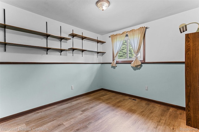 1306 Bishops Ter, Wixom, MI 48393 - unfurnished room featuring wood finished floors