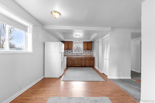 322 Michelson Rd, Rochester Hills, MI 48307 - kitchen featuring freestanding refrigerator, a tray ceiling, healthy amount of natural light, and light wood finished floors