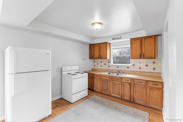 322 Michelson Rd, Rochester Hills, MI 48307 - kitchen featuring white appliances, light countertops, brown cabinets, tasteful backsplash, and light wood-type flooring