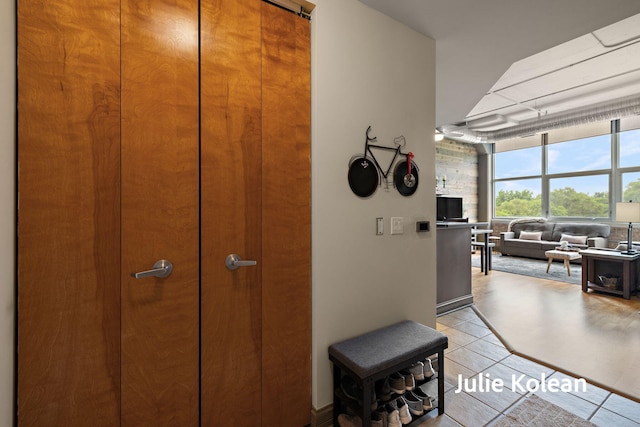 930 Washington Ave Unit 5C, Muskegon, MI 49441 - hallway featuring floor to ceiling windows and light tile patterned flooring