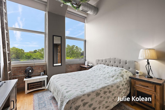930 Washington Ave Unit 5C, Muskegon, MI 49441 - bedroom featuring multiple windows and light wood finished floors