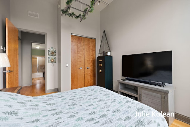 930 Washington Ave Unit 5C, Muskegon, MI 49441 - bedroom with a towering ceiling, wood finished floors, and a closet