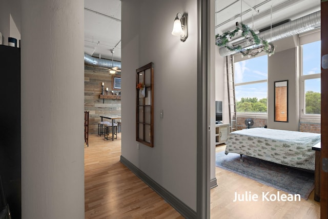 930 Washington Ave Unit 5C, Muskegon, MI 49441 - hallway featuring a towering ceiling, wood finished floors, and rail lighting