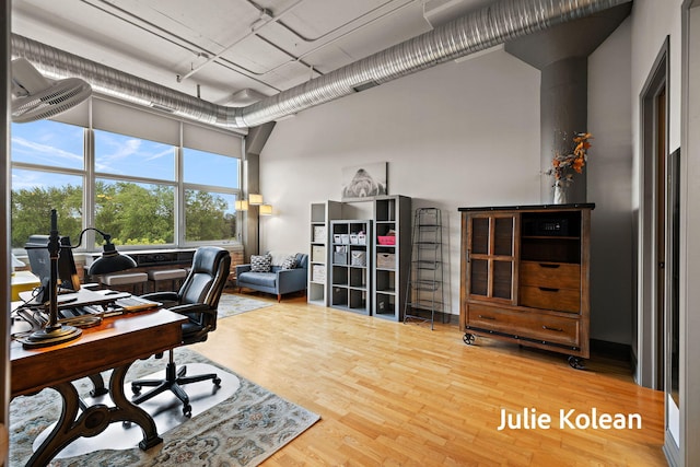930 Washington Ave Unit 5C, Muskegon, MI 49441 - office area with a towering ceiling and wood finished floors
