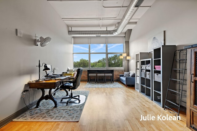 930 Washington Ave Unit 5C, Muskegon, MI 49441 - office area with wood finished floors and a towering ceiling