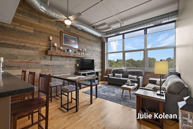 930 Washington Ave Unit 5C, Muskegon, MI 49441 - living area with wooden walls, ceiling fan, and wood finished floors