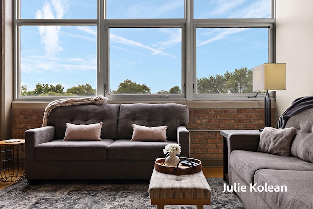 930 Washington Ave Unit 5C, Muskegon, MI 49441 - living area featuring wood finished floors and brick wall
