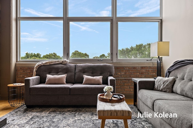 930 Washington Ave Unit 5C, Muskegon, MI 49441 - living area with wood finished floors and brick wall