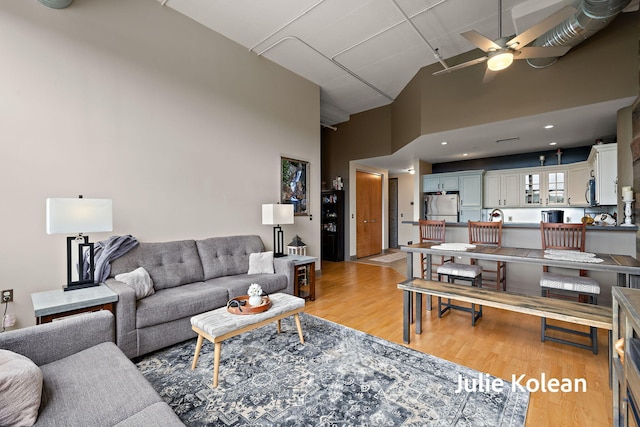930 Washington Ave Unit 5C, Muskegon, MI 49441 - living area with a ceiling fan, light wood-type flooring, and high vaulted ceiling