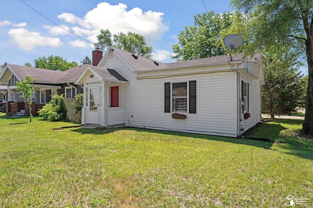 1107 W Temperance Rd, Temperance, MI 48182 - view of front of house with a front yard and a chimney