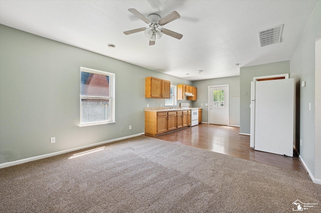 1107 W Temperance Rd, Temperance, MI 48182 - kitchen featuring white appliances, dark colored carpet, open floor plan, and a ceiling fan