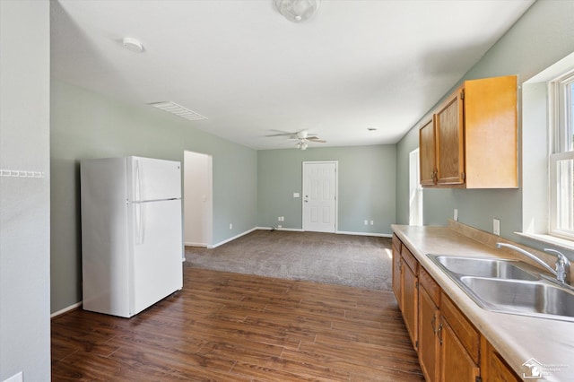 1107 W Temperance Rd, Temperance, MI 48182 - kitchen with freestanding refrigerator, dark wood finished floors, ceiling fan, and light countertops