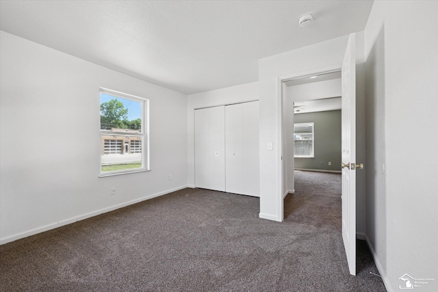 1107 W Temperance Rd, Temperance, MI 48182 - unfurnished bedroom with dark colored carpet and a closet
