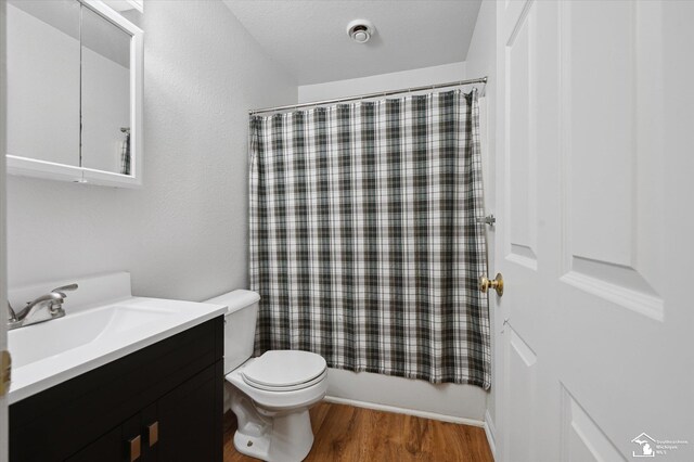 1107 W Temperance Rd, Temperance, MI 48182 - full bathroom featuring vanity, wood finished floors, and shower / bath combination with curtain