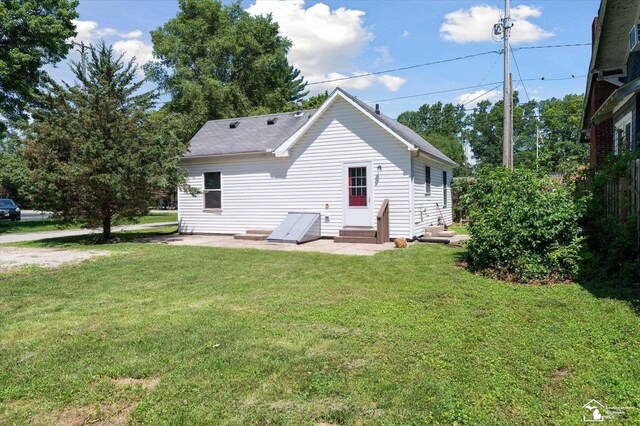 1107 W Temperance Rd, Temperance, MI 48182 - rear view of property with a yard, entry steps, and a patio area