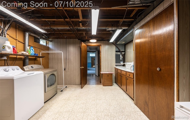 2150 Dunwoodie St, Ortonville, MI 48462 - washroom featuring washer and clothes dryer, light floors, and wood walls