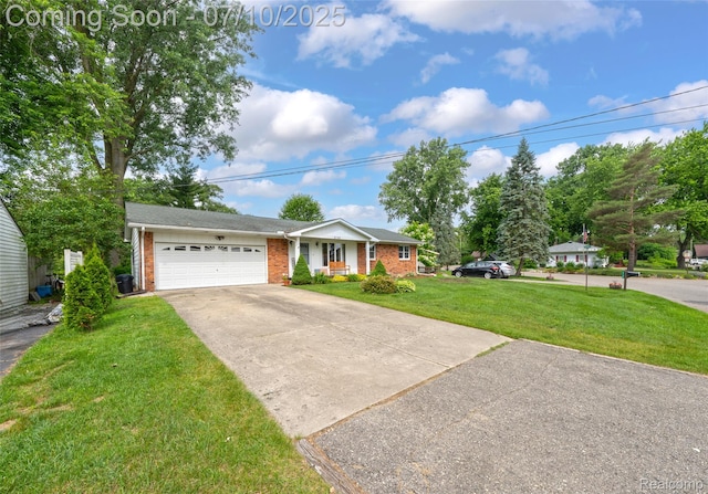 2150 Dunwoodie St, Ortonville, MI 48462 - ranch-style home with brick siding, concrete driveway, a front yard, and an attached garage