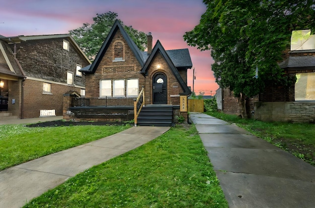 5544 Balfour Rd, Detroit, MI 48224 - tudor home featuring a chimney, brick siding, and a front yard