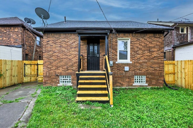 5544 Balfour Rd, Detroit, MI 48224 - rear view of property featuring brick siding, roof with shingles, a fenced backyard, and a gate