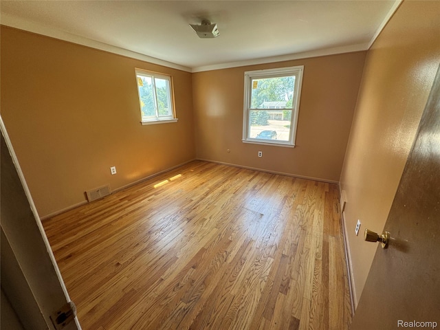 28330 Lahser Rd, Southfield, MI 48034 - spare room with healthy amount of natural light, light wood-type flooring, and crown molding