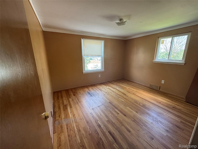 28330 Lahser Rd, Southfield, MI 48034 - unfurnished room with plenty of natural light, wood finished floors, and crown molding