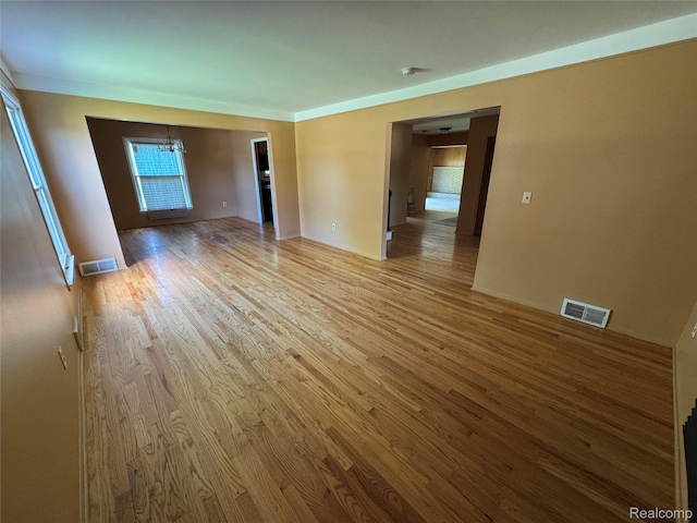 28330 Lahser Rd, Southfield, MI 48034 - unfurnished room featuring light wood finished floors and a chandelier