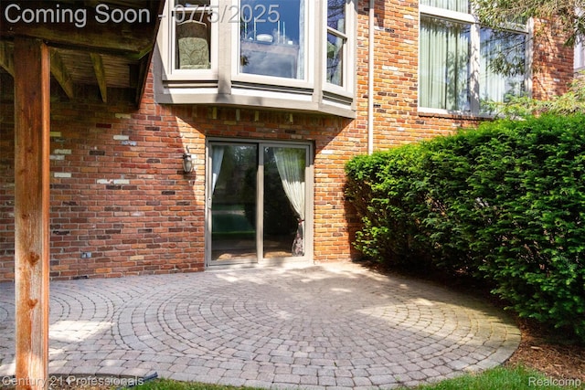 6626 Lake Pointe, Shelby Twp, MI 48317 - doorway to property with brick siding and a patio