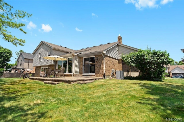 20213 Whitby Dr, Livonia, MI 48152 - back of house with brick siding, a chimney, a lawn, and a patio area