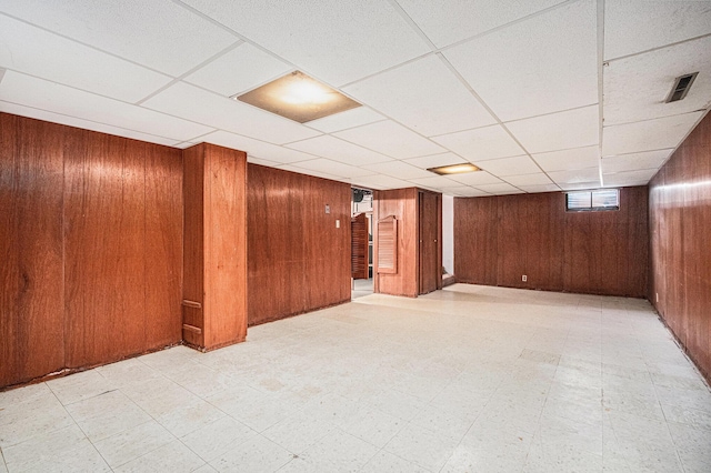 981 Vinewood Dr, Saint Joseph, MI 49085 - basement with wooden walls, tile patterned floors, and a paneled ceiling