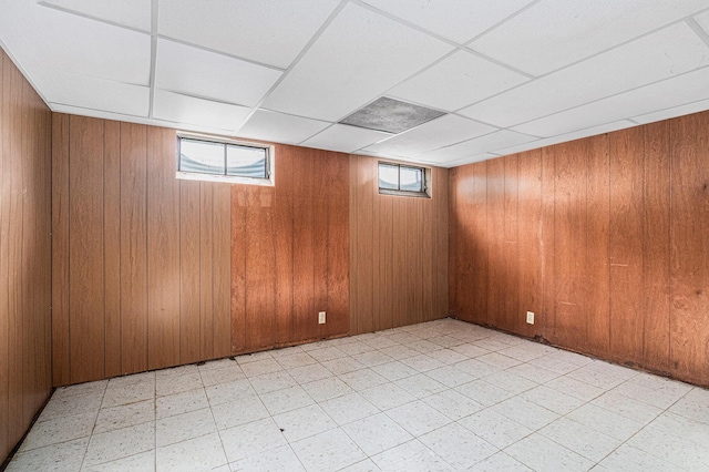 981 Vinewood Dr, Saint Joseph, MI 49085 - basement with wood walls, light floors, and a paneled ceiling