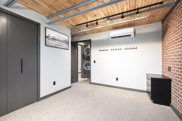 220 King St Unit 6, Lowell, MI 49331 - below grade area with estacked washer and dryer, a wall unit AC, brick wall, and light colored carpet