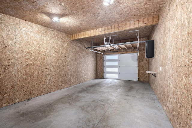 220 King St Unit 6, Lowell, MI 49331 - garage featuring a garage door opener