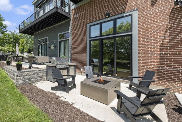 220 King St Unit 6, Lowell, MI 49331 - patio / terrace featuring an outdoor fire pit, a patio, and an outdoor kitchen