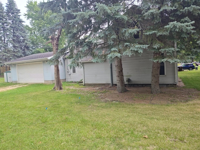 203 E Home St, Edmore, MI 48829 - view of property exterior with driveway, a lawn, and an attached garage