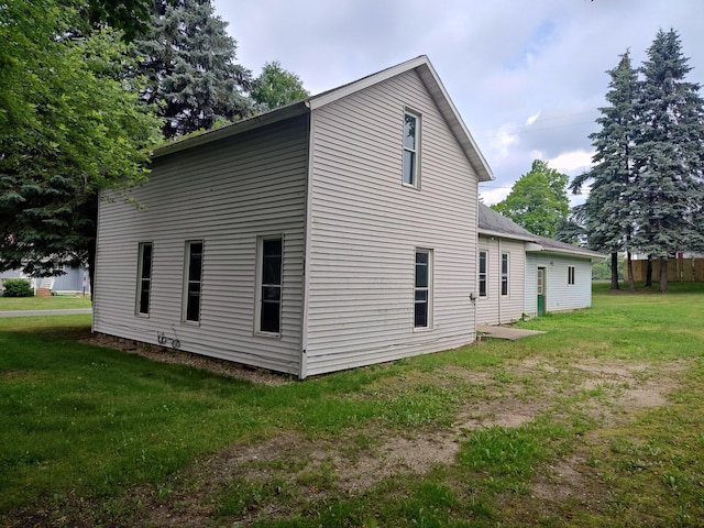 203 E Home St, Edmore, MI 48829 - view of home's exterior featuring a yard