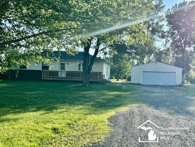 13091 Rosedale Blvd, Carleton, MI 48117 - view of green lawn with a detached garage, an outbuilding, and a wooden deck